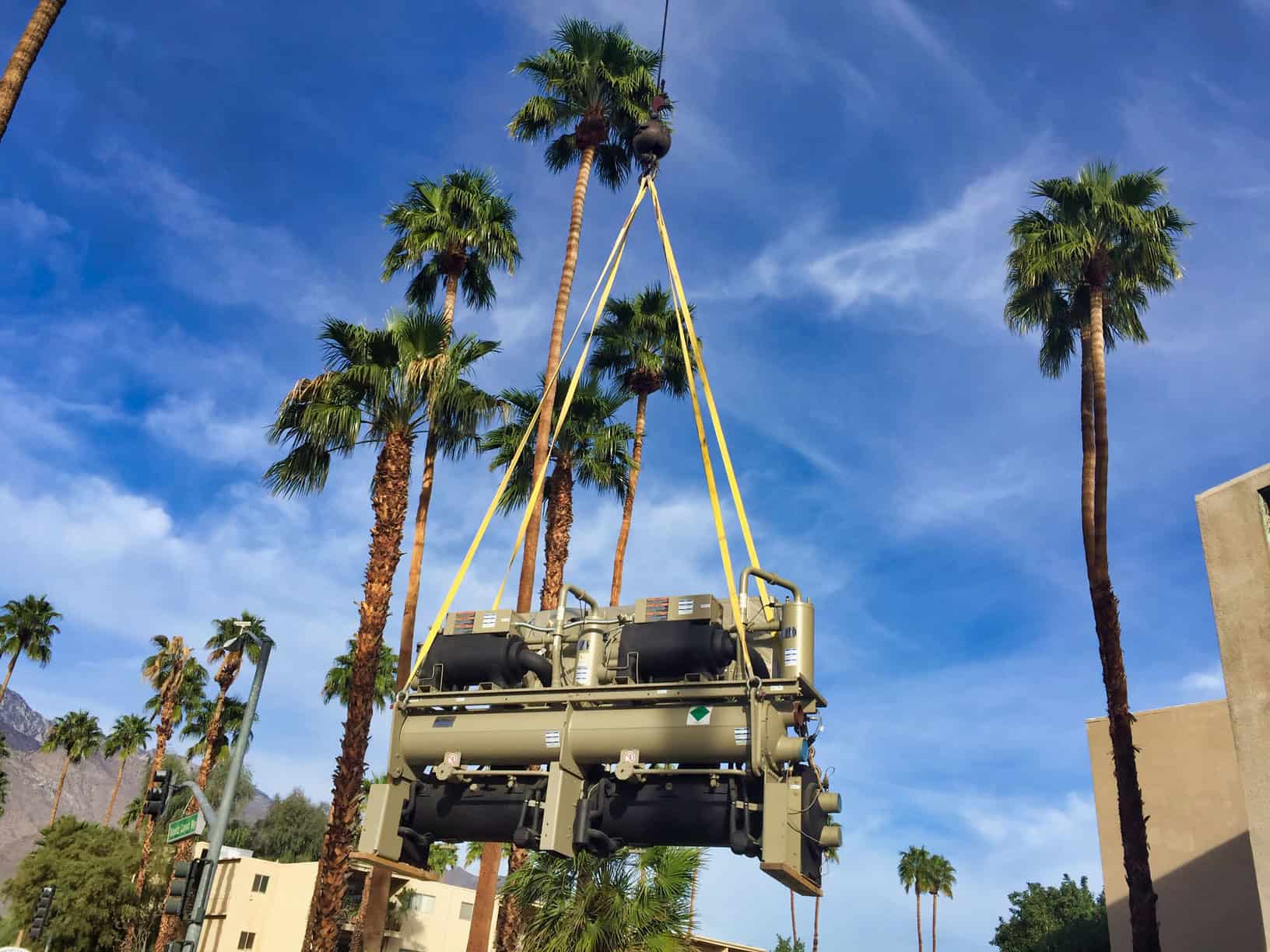 Desert Tech lifting a commercial chiller into place by crane