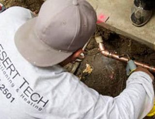 Desert Tech technician performing service at a commercial customer's site